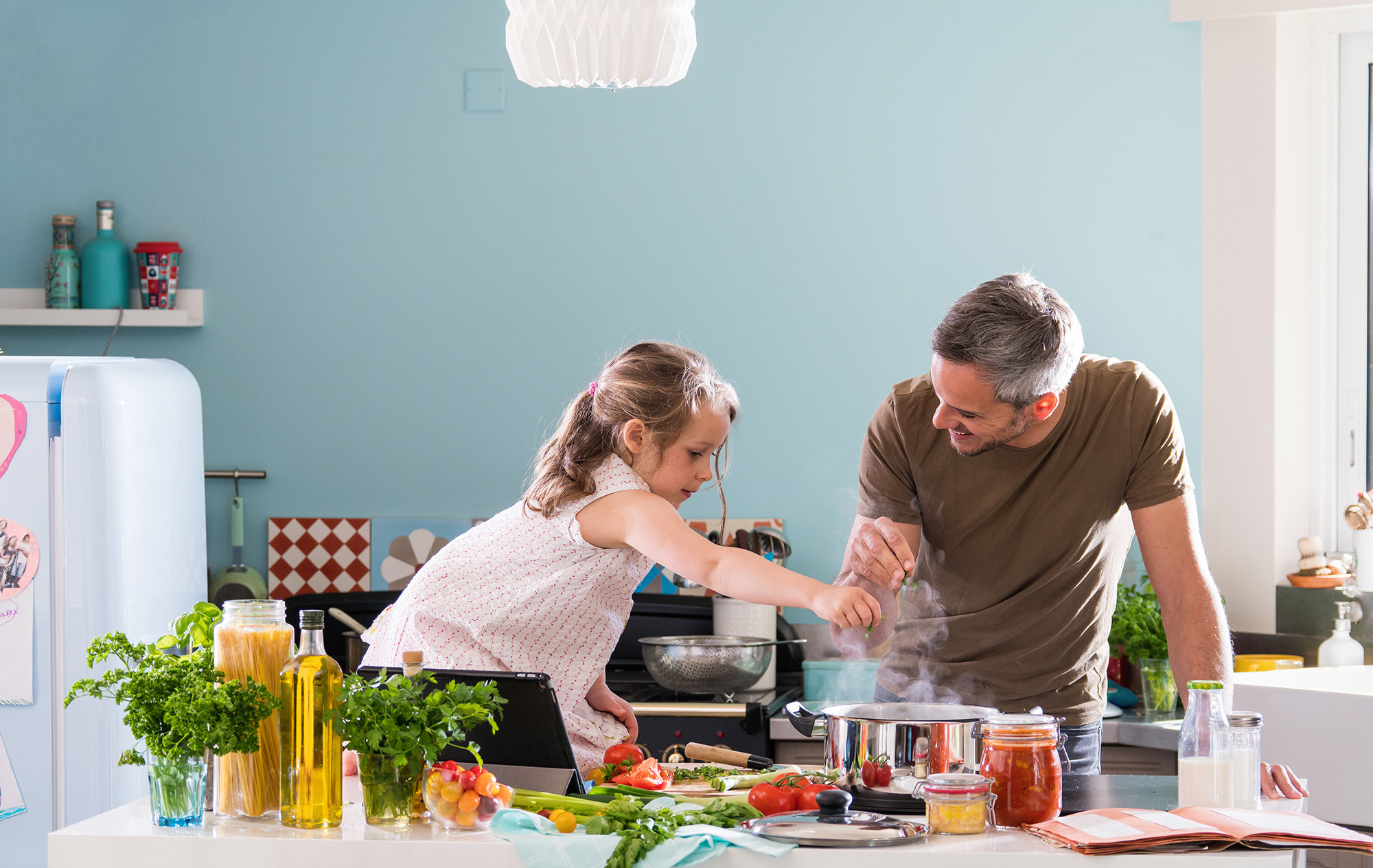 Individual and Family Health Insurance Family on Insurance cooking in the kitchen together