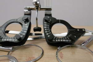 Eye exam tool sitting on a wooden desk.