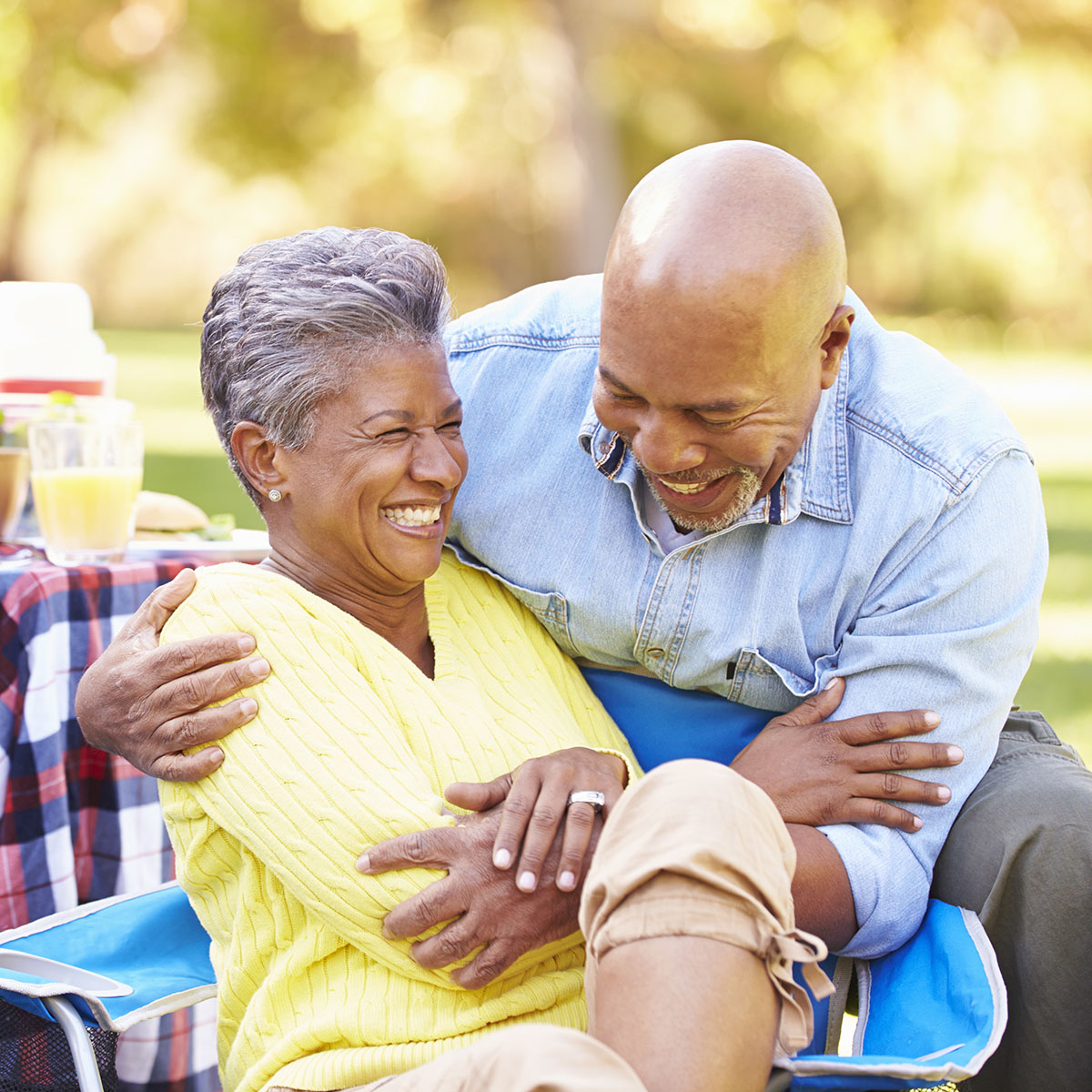 Health Care Coverage for Retiree Happy couple laughing during their picnic