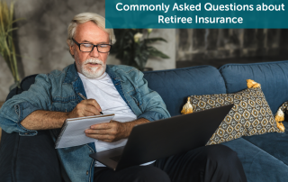 White senior man, sitting on a green couch with a laptop in his lap, writing down retiree insurance questions in a notebook.